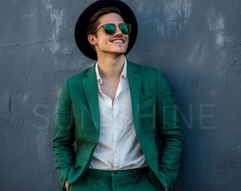 May include: A man wearing a green linen suit jacket and matching trousers. He is also wearing a white linen shirt, a black fedora hat, and green sunglasses.