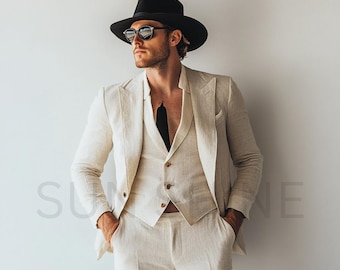 May include: A man wearing a white linen suit with a black fedora and sunglasses. The suit has a vest and a jacket with a single button.