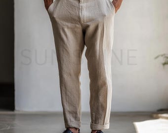 May include: A pair of beige linen pants with a straight leg fit. The pants have a button and zipper closure and are cuffed at the bottom.