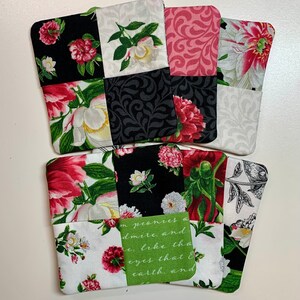 May include: Four square fabric coasters with a patchwork design featuring floral patterns in shades of pink, white, black, and green. The coasters have a quote on one of them that reads "I  peonies a admire, and e, like the eyes that & earth, and"