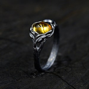 Mystical Black Witch's Wedding Ring featuring an Oval Citrine Stone and Moon-inspired Leaf Ornamentation, Whimsical Wedding Ring for Witches