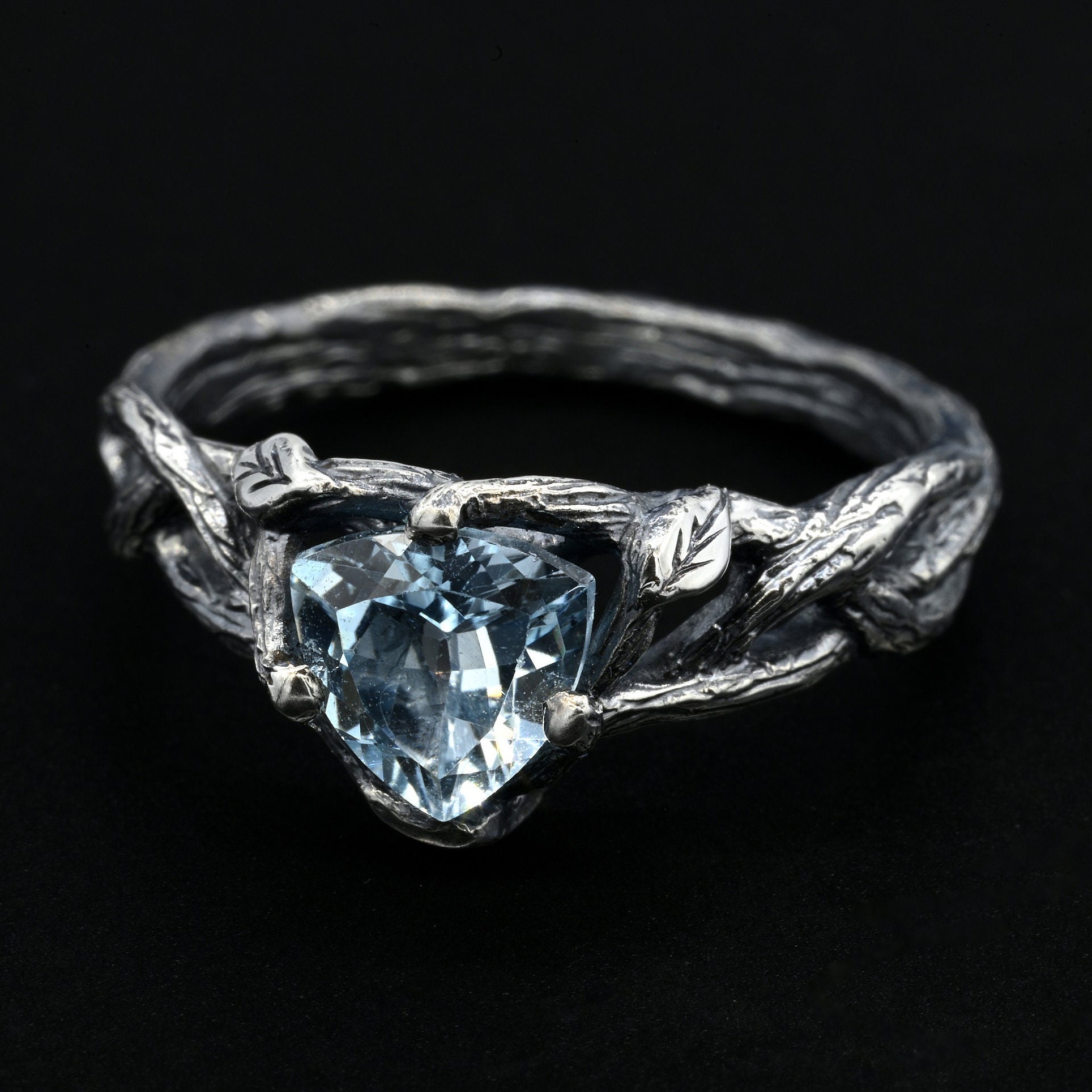 Silver Ring with Heart-Cut Blue Topaz and Twisting Branch Design