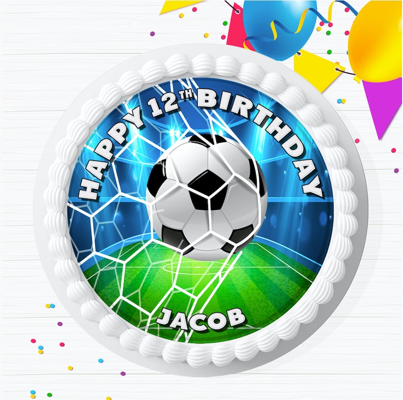 May include: A white cake with a round edible image of a soccer ball going into the net. The image has a blue background with white and green accents. The text "Happy 12th Birthday Jacob" is printed on the image.
