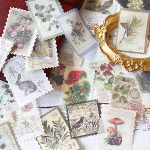 May include: A collection of vintage-style postage stamps with botanical and animal illustrations. The stamps feature images of flowers, mushrooms, an owl, a rabbit, and other nature-themed designs. Some stamps have a value of 50, 15, or 35. The stamps are arranged on a red surface.