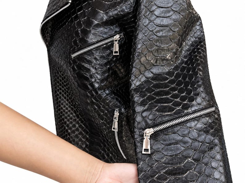 Close-up of black genuine python snakeskin leather jacket texture and zipper details