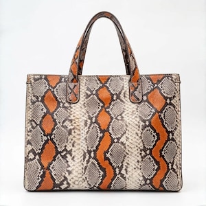 Front view of orange genuine python snakeskin tote bag luxury handbag