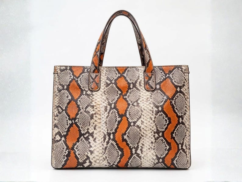 Front view of orange genuine python snakeskin tote bag luxury handbag