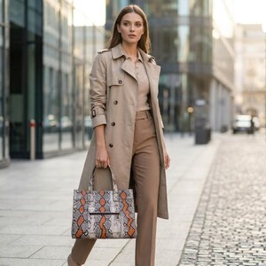 Fashion model carrying exotic python leather tote bag on city street
