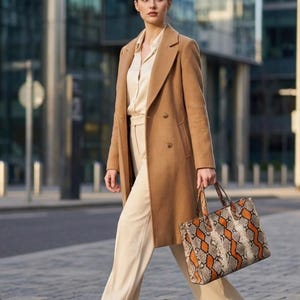 Street style fashion with genuine python snakeskin tote bag and camel coat