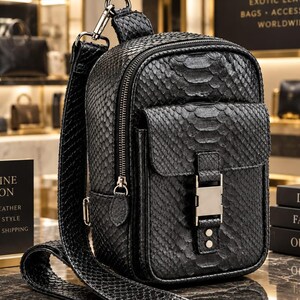 Black genuine python snakeskin backpack displayed in luxury leather boutique with exotic texture