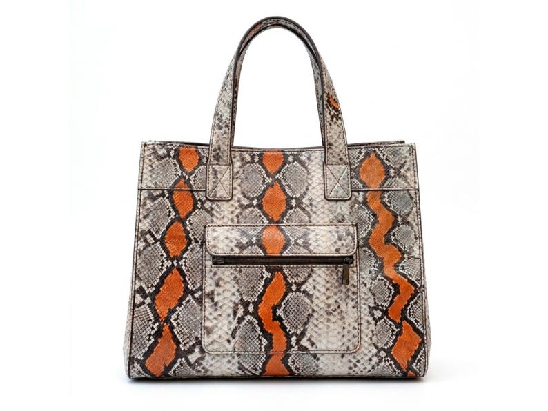 Front view of orange genuine python snakeskin tote bag with zip pocket