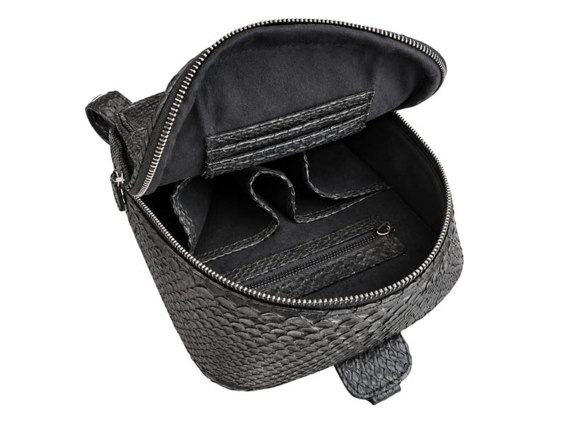 Open black python snakeskin backpack showing spacious interior, organizer pockets and zippered compartment