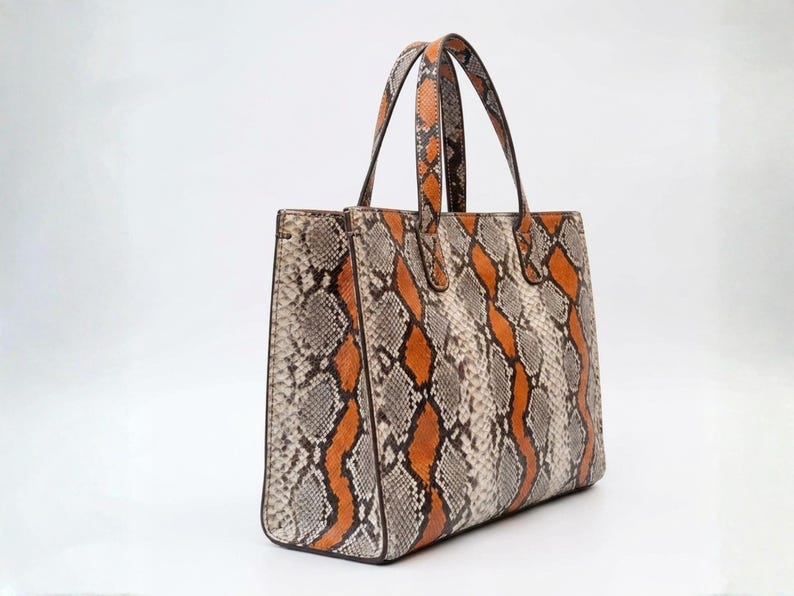 Side angle of exotic python leather tote bag with shoulder straps