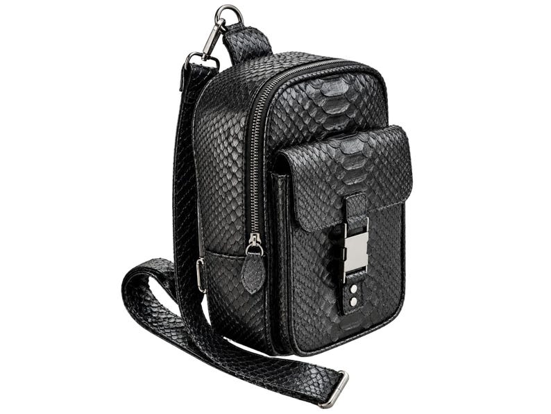 Black genuine python leather crossbody sling backpack angled view showing front pocket zipper and buckle