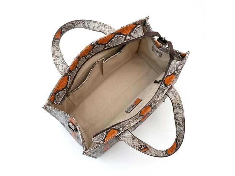 Interior compartment of luxury python leather tote bag with organizer pockets