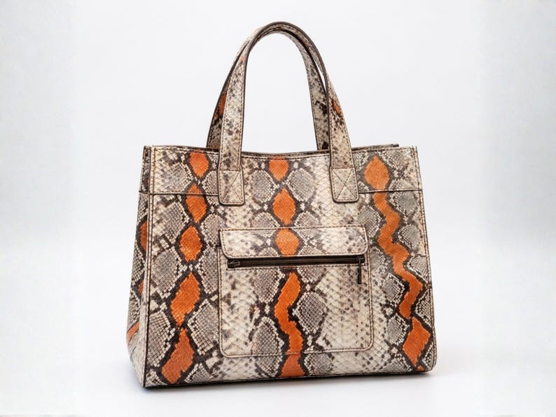 Side perspective of exotic orange snakeskin leather tote bag