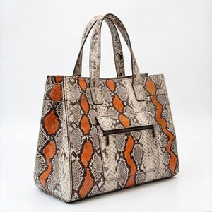 Angled view of luxury python leather shoulder tote handbag