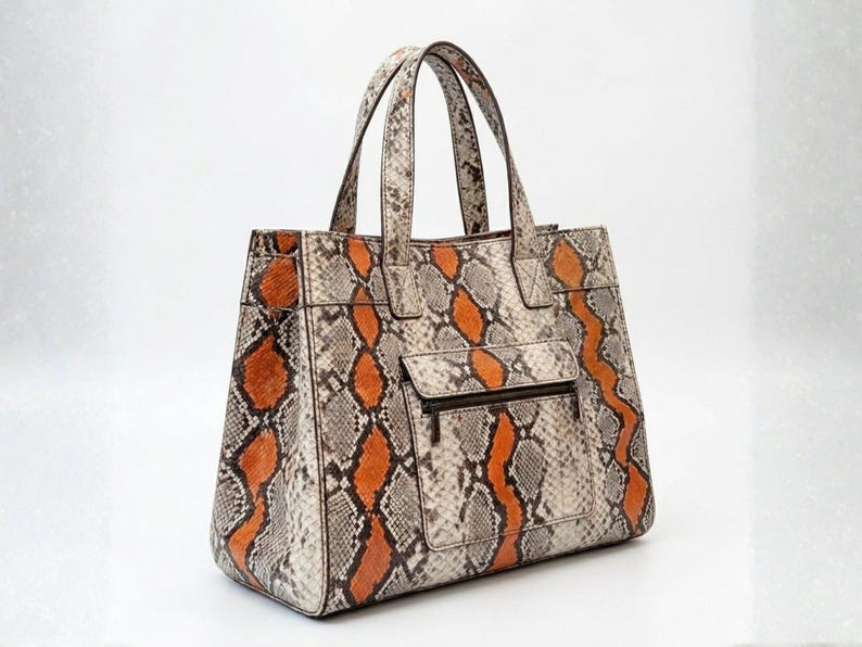 Angled view of luxury python leather shoulder tote handbag