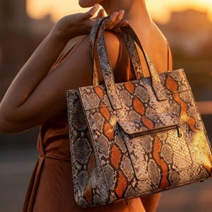 Luxury snakeskin shoulder handbag in golden sunset fashion styling