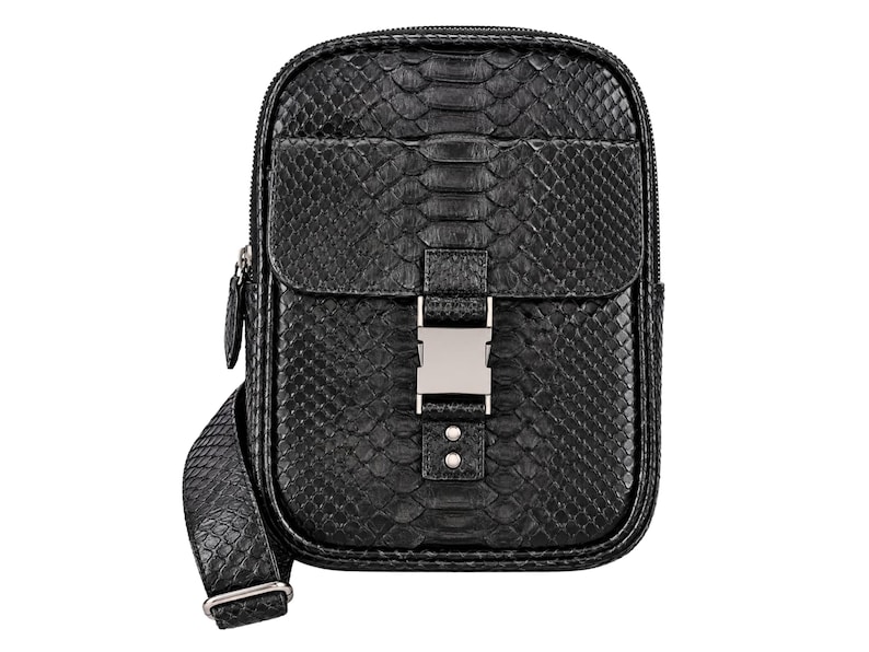 Black genuine python snakeskin crossbody sling backpack front detail with natural scale pattern and metal buckle