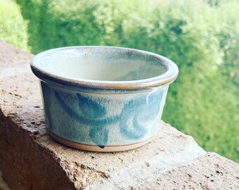 Pale green jewellery/dip dish with blue leaf design.