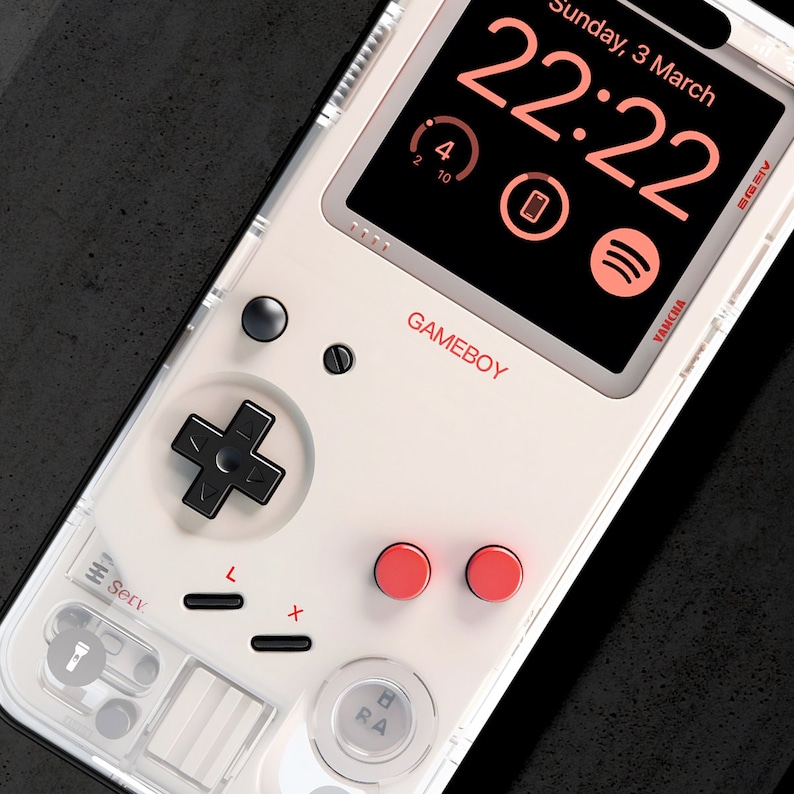 May include: A white Game Boy-style phone case with a black and white Game Boy controller design. The phone screen displays a digital clock with the date "Sunday, 3 March" and the time "22:22".