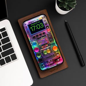 May include: A colorful phone case with a digital clock displaying "17:03" and a rainbow-colored design resembling a music mixer with buttons and knobs.