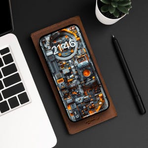 May include: A brown leather phone case with a black iPhone inside. The phone screen displays a digital clock showing the time 21:46 and the date Thursday, 26 July. The phone background is a colourful abstract design of gears and machinery.