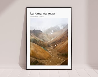 May include: A poster with a photograph of a mountain valley in Iceland. The valley is filled with colorful rock formations and a winding river. The text "Landmannalaugar" is at the top of the poster, with the words "Nordic Nature - Iceland" below it.