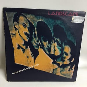 May include: A black vinyl record album cover with a yellow, blue, and green image of four people. The album title is "Landscape" and the song title is "Manhattan Boogie Woogie".
