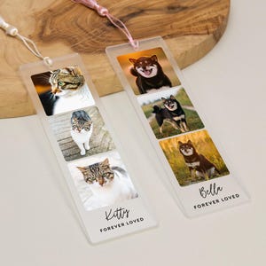 May include: Two clear acrylic bookmarks with photos of pets. One bookmark features three cat photos and the text "Kitty FOREVER LOVED." The other bookmark has three dog photos and the text "Bella FOREVER LOVED."
