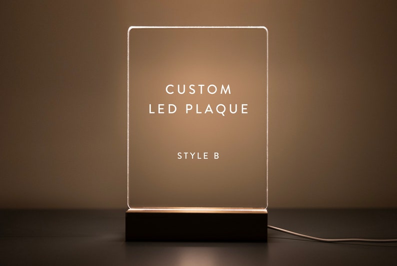 This custom LED plaque design (Style B) offers a clean and modern look. The illuminated acrylic with a wooden base provides a sophisticated touch, making it perfect for personalized messages, quotes, or photos.