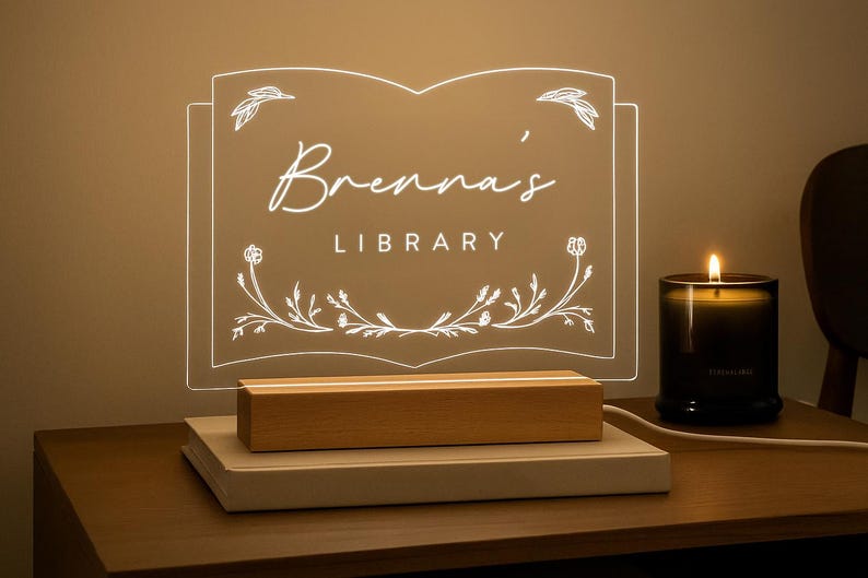 Personalized Library Sign on a clear acrylic book-shaped plaque, featuring floral details and a wood LED base.