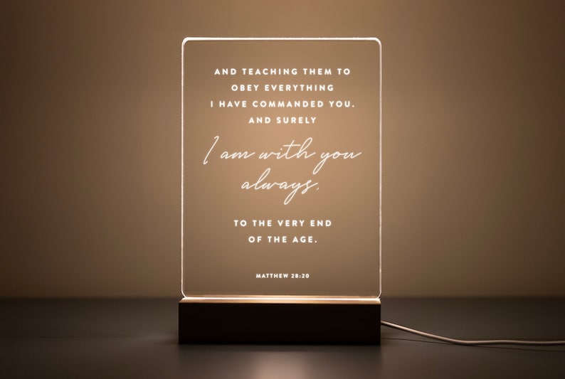 Personalized LED light featuring the comforting Bible verse from Matthew 28:20: "And surely I am with you always, to the very end of the age." Engraved on a clear acrylic plaque with a warm wooden base, perfect for home décor, prayer spaces, or as a thoughtful Christian gift.