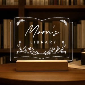 Personalized Library Sign on a clear acrylic book-shaped plaque, featuring floral details and a wood LED base.