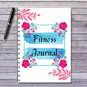 May include: A white spiral bound journal with a blue and teal watercolor design. The journal has the words "Fitness Journal" written in black. The cover is decorated with pink flowers and leaves.