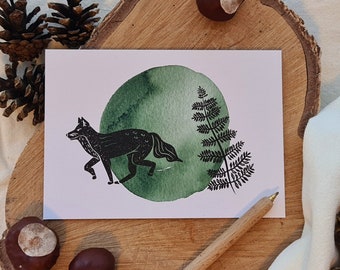 May include: A black and white illustration of a wolf walking through a green forest. The wolf is in the foreground, and the forest is in the background. The illustration is on a white card.