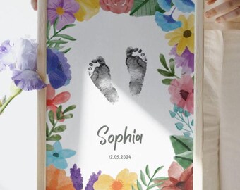 May include: A framed print featuring baby footprints, surrounded by a watercolor floral border. The print includes the name "Sophia" and the date "12.05.2024". The frame is made of light-colored wood.