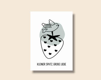 May include: A white card featuring a black and white illustration of a strawberry with heart-shaped seeds and a bird perched on top. A gray shape is behind the bird. The text "KLEINER SPATZ, GROBE LIEBE" is at the bottom.