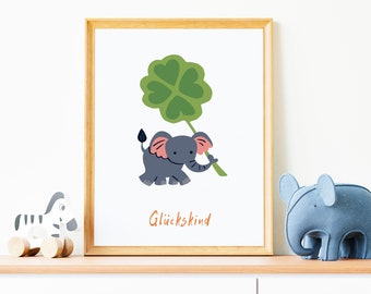 May include: A framed print with a cartoon illustration of a gray elephant holding a green four-leaf clover. The text "Glückskind" is printed below the elephant.