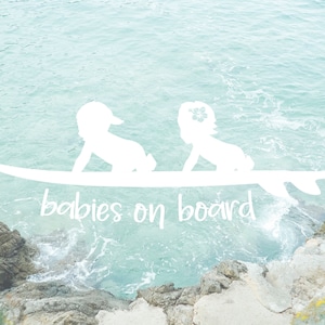 May include: White silhouette of two babies on a surfboard with the text "babies on board" in white against a blue water background.