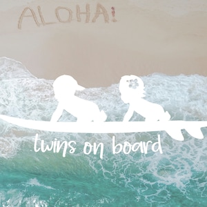 May include: White silhouette of twins riding a surfboard with the text "twins on board" on a turquoise and white ocean background. The word "ALOHA!" is written in the sand above the twins.