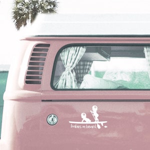 May include: A pink vintage van with a white sticker on the back that says "babies on board". The sticker shows two children on a surfboard.
