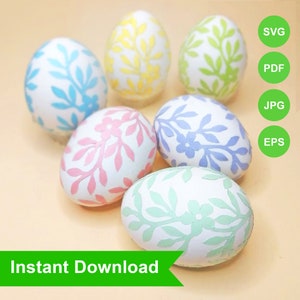 May include: Six white Easter eggs with floral patterns in blue, pink, yellow, and green. The eggs are arranged on a light orange surface. The words "Instant Download" are displayed on a green banner.