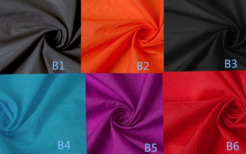 K&ouml;nnte beinhalten: Sechs Stoffmuster in verschiedenen Farben: Schwarz, Orange, T&uuml;rkis, Lila, Rot und Schwarz. Jedes Muster ist mit einem Buchstaben und einer Nummer von B1 bis B6 gekennzeichnet.