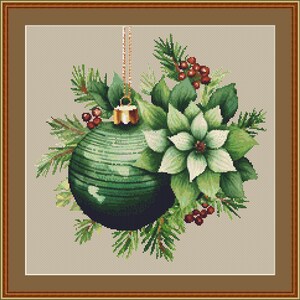 May include: A green Christmas bauble with a gold bell hanging from a gold chain, surrounded by green pine branches and white poinsettia flowers with red berries.