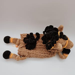 Crochet horse pajama bag plush toy in brown with black mane and hooves. Back view