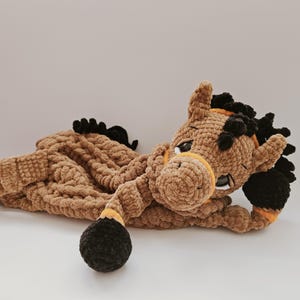 Handmade crochet brown horse pajama holder plush toy, soft yarn, child’s comfort bag. Horse is lying down and keeping front leg under head
