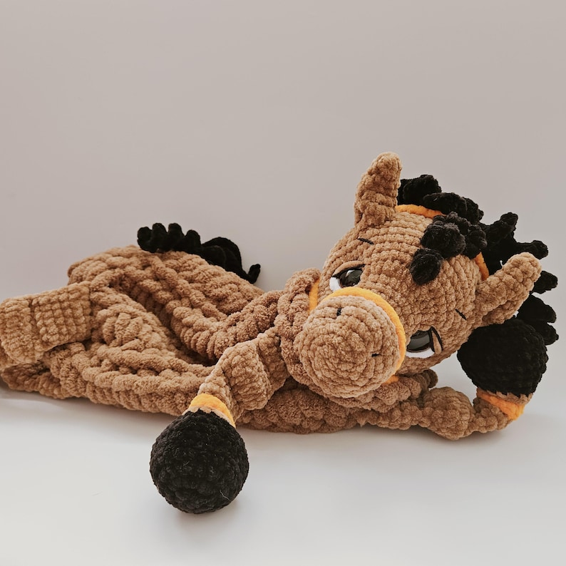 Handmade crochet brown horse pajama holder plush toy, soft yarn, child’s comfort bag. Horse is lying down and keeping front leg under head
