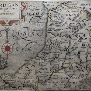 May include: An antique map of Wales, showing the counties of Cardigan, Merioneth, Montgomery, Radnor, Brecknock, and Carmarthen. The map is drawn in black ink on a parchment-like background with handwritten text and illustrations of mountains, rivers, and towns.